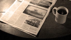 A plain white mug of black tea or coffee, next to a broadsheet paper on a table, in black and white. It's the header for Sunday Papers!